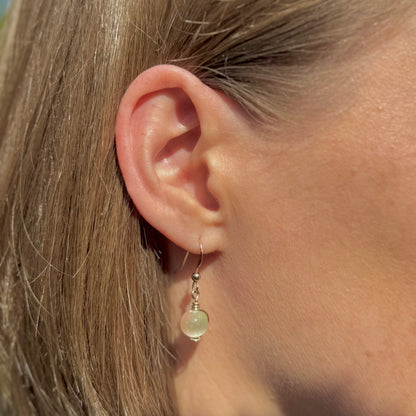 Gold filled wire-wrapped gemstone drop earrings on a model