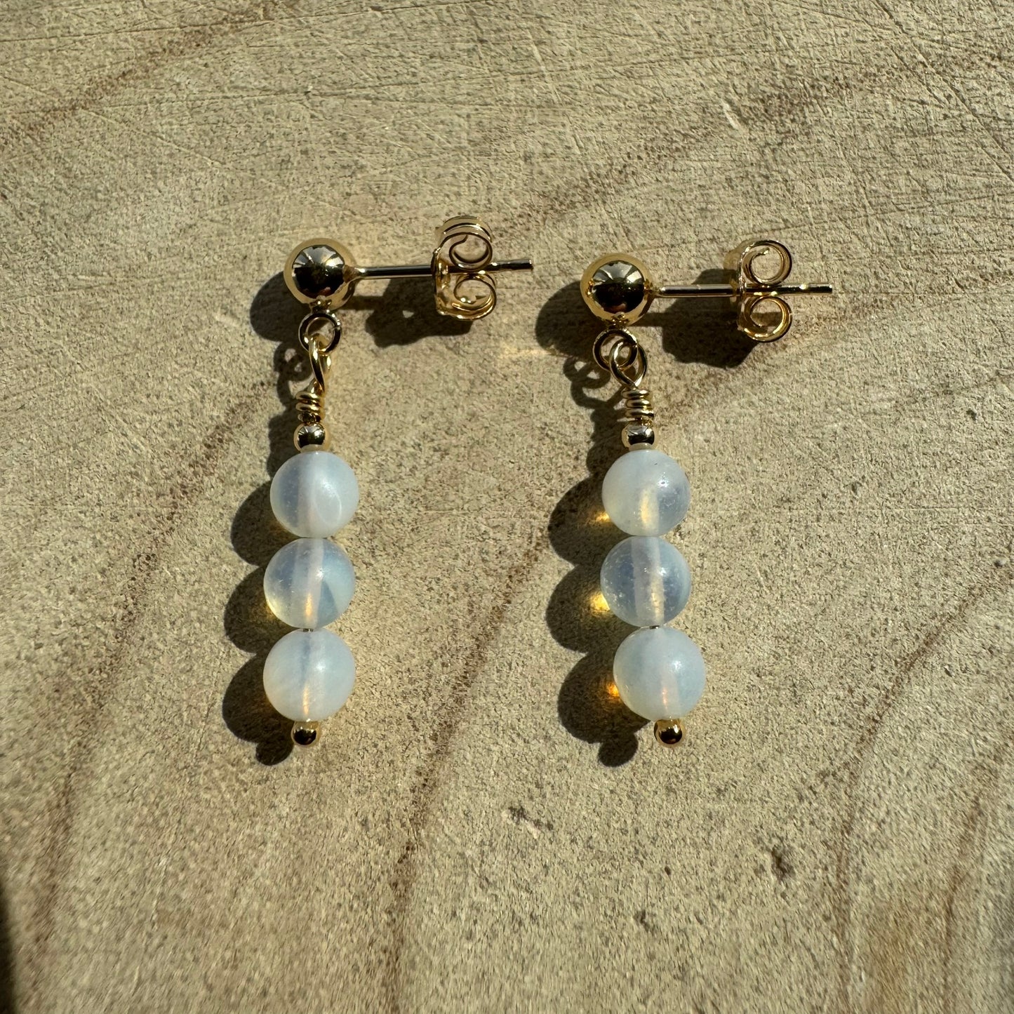 Pair of Gold Filled opalite earrings on wooden surface