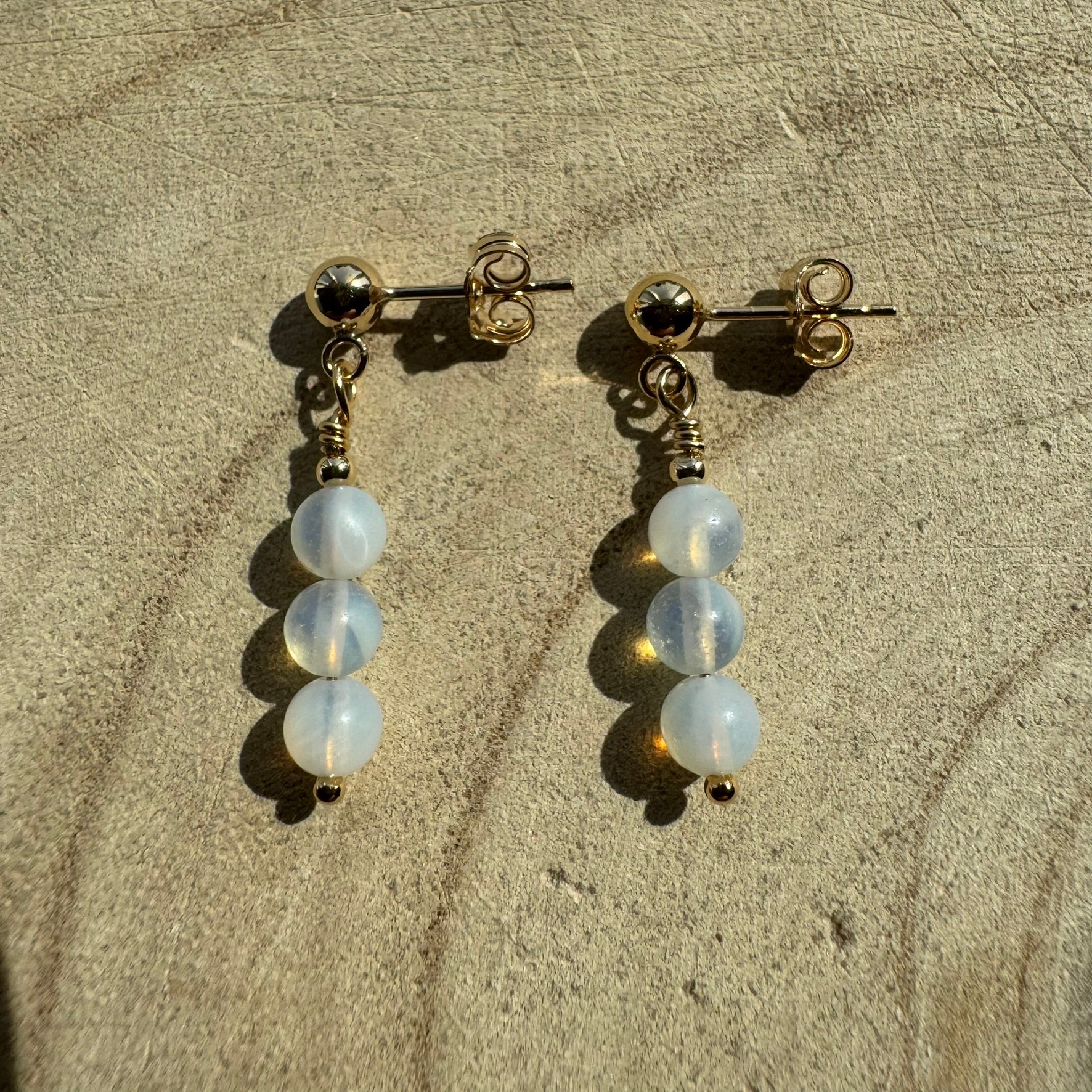 Pair of Gold Filled opalite earrings on wooden surface