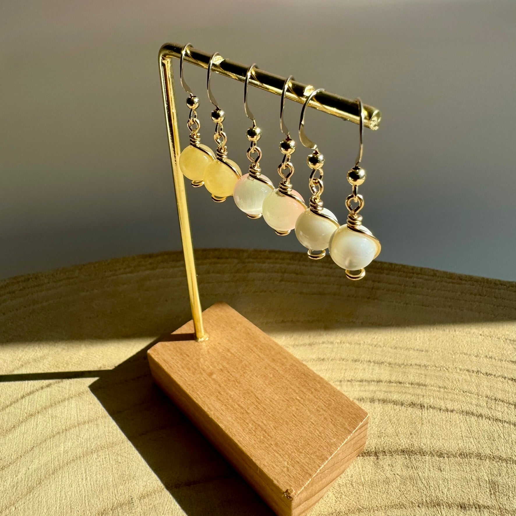 Gold filled gemstone drop earrings on display stand