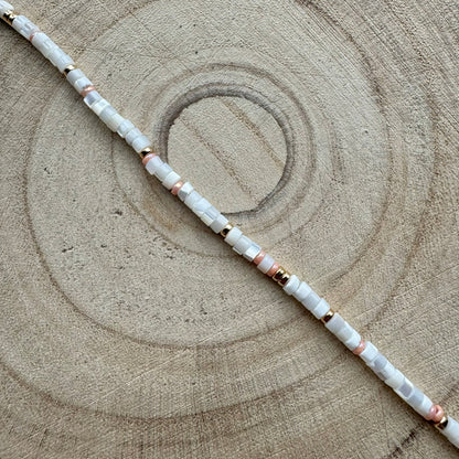 Close-up of handmade mother of pearl and peach seed bead gold filled bracelet