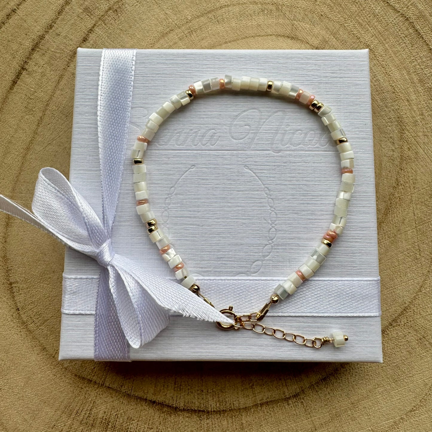 Mother of pearl and gold filled bracelet on a white gift box with ribbon