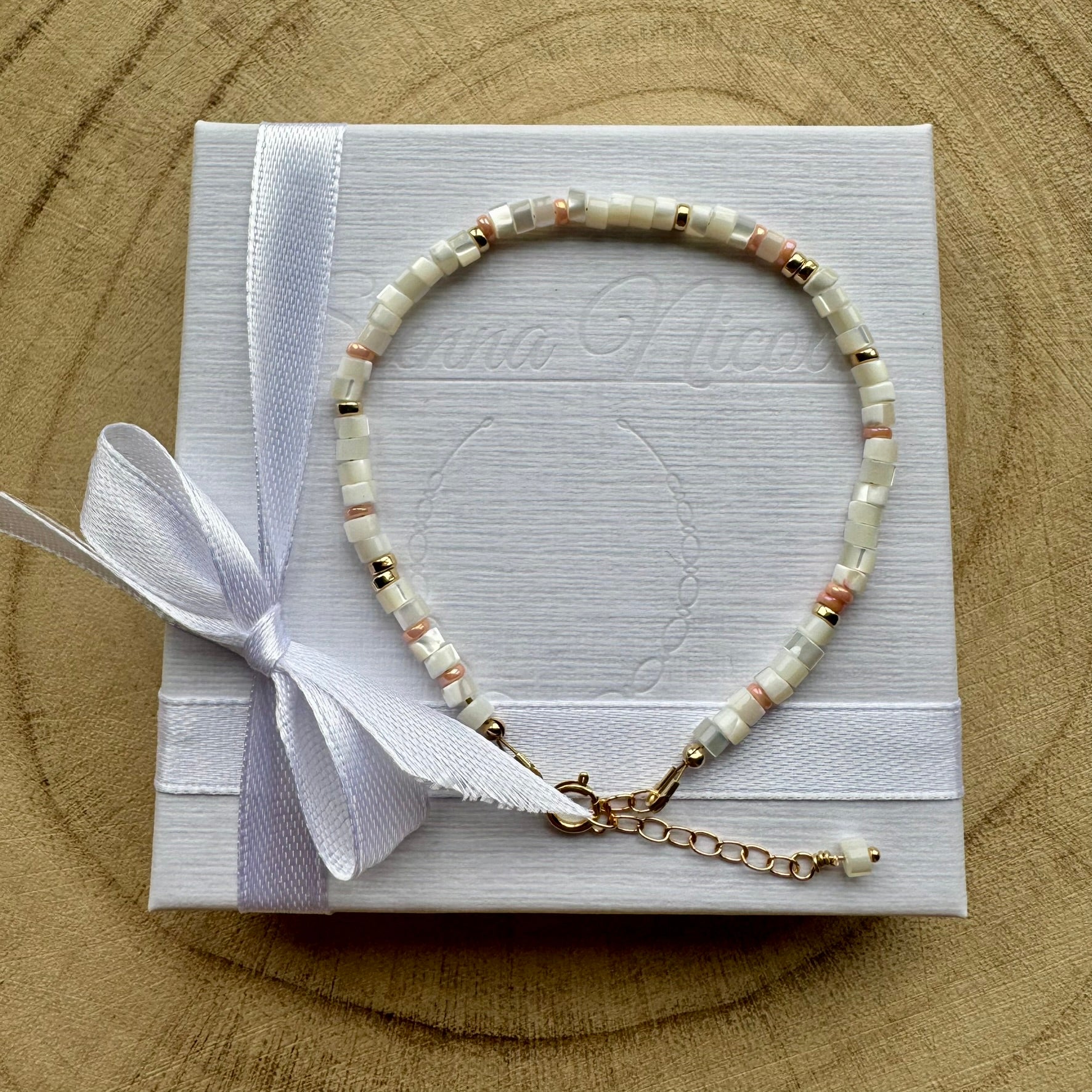Mother of pearl and gold filled bracelet on a white gift box with ribbon