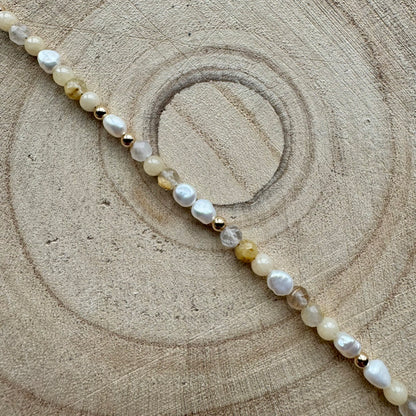 Pearl and mixed gemstone bracelet with gold filled details on wooden surface