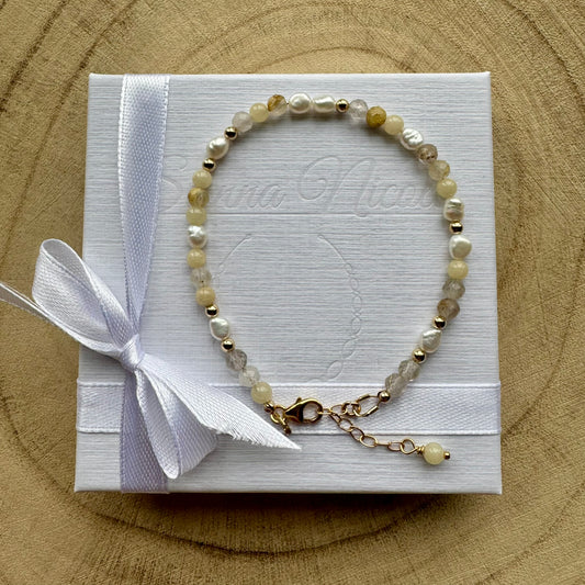 Pearl and mixed gemstone bracelet with gold filled details on gift packaging