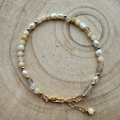 Pearl and mixed gemstone bracelet with gold filled details on wooden surface