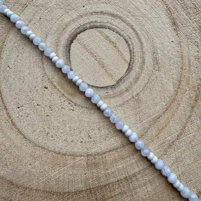 Pale blue gemstone beaded bracelet on wooden surface
