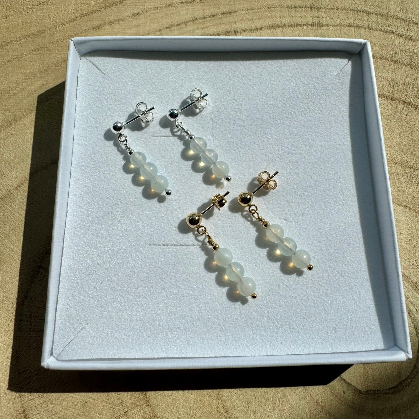 Image showing the same opailte earrings, one pair in sterling silver and one is gold filled