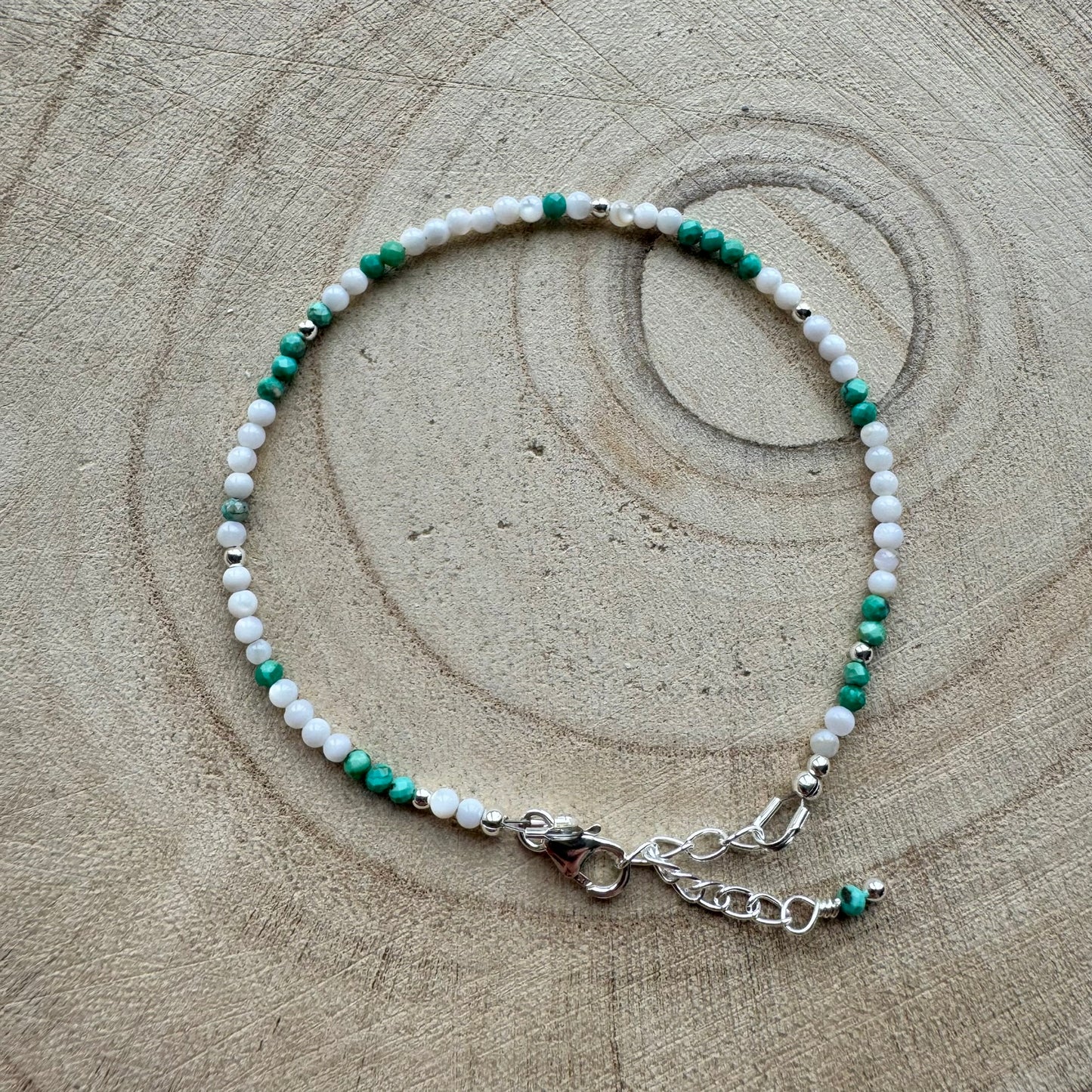 Mother of Pearl and turquoise bracelet on a wooden background