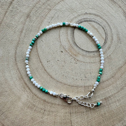 Mother of Pearl and turquoise bracelet on a wooden background