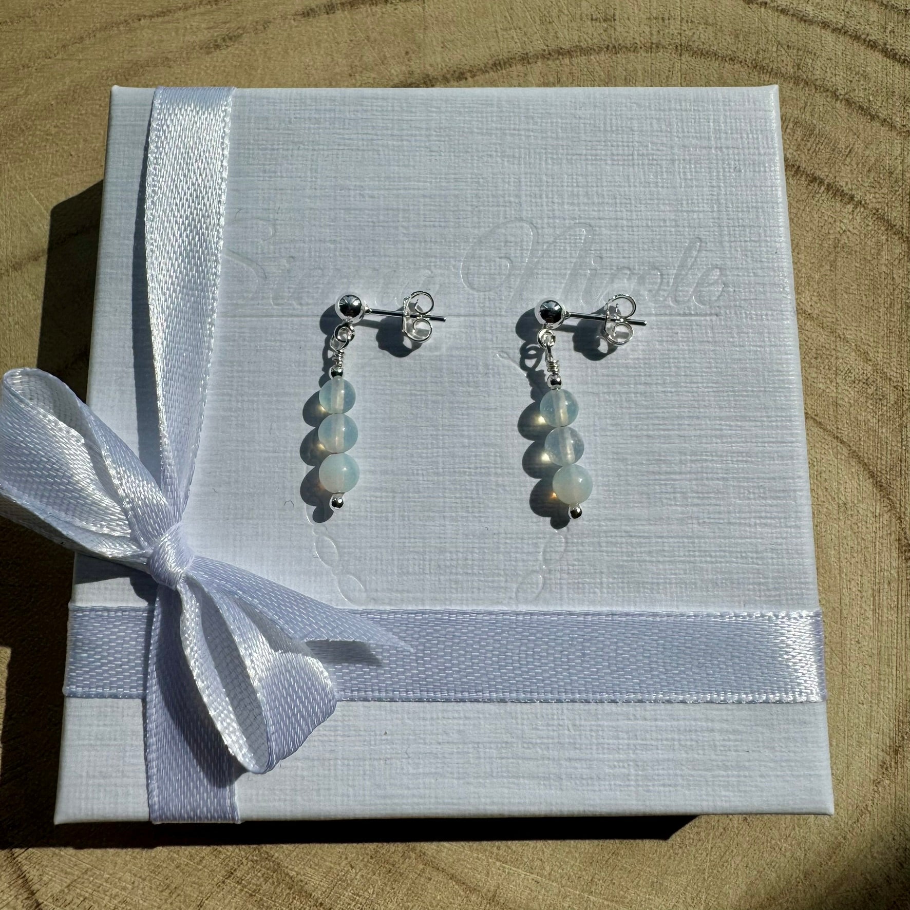 Pair of Sterling silver opalite earrings on white gift packaging