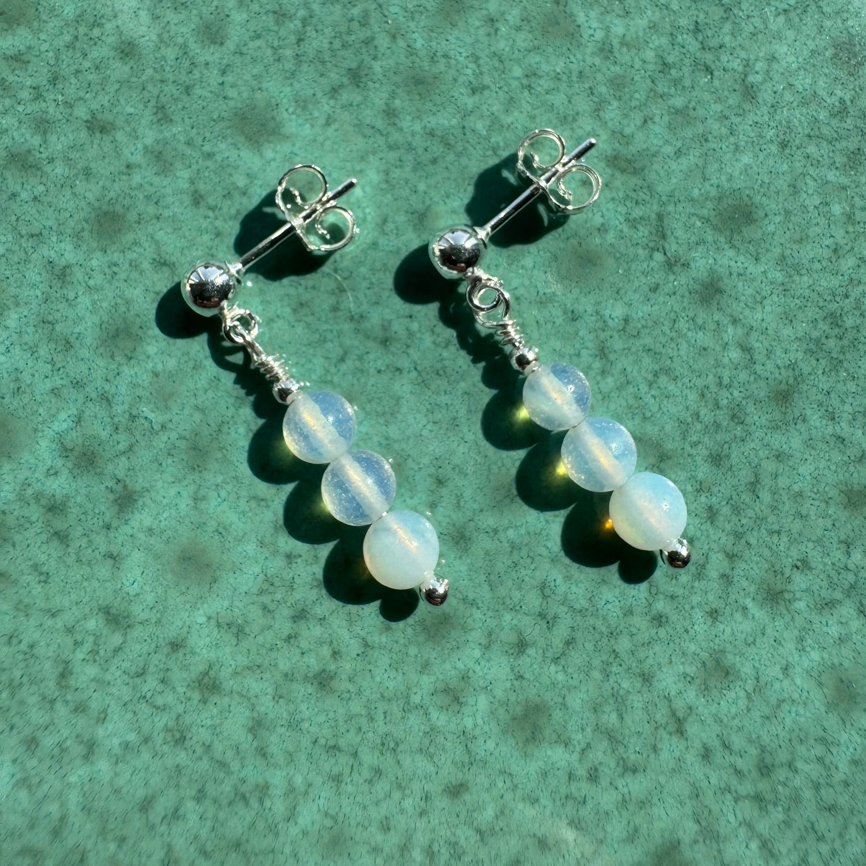 Pair of Sterling silver opalite earrings on ceramic surface