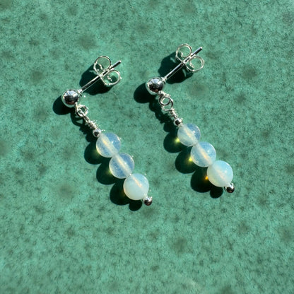 Pair of Sterling silver opalite earrings on ceramic surface
