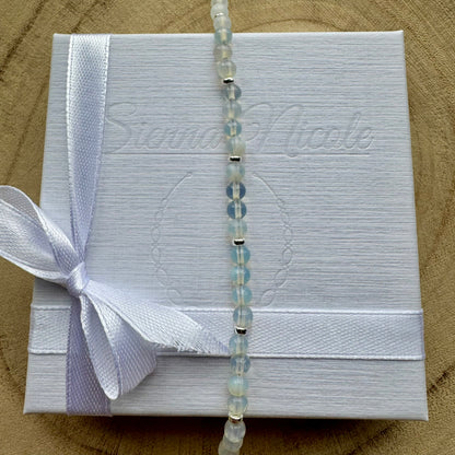 Vertical view of sterling silver opalite bracelet on gift packaging
