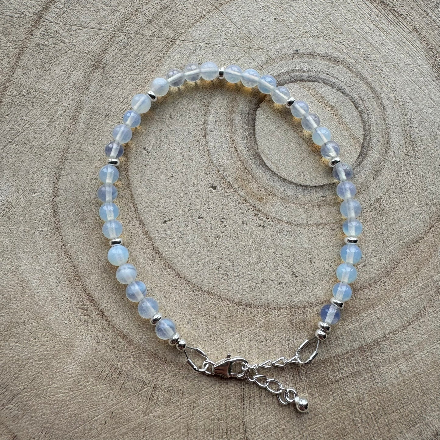 Sterling silver opalite bracelet on wooden surface