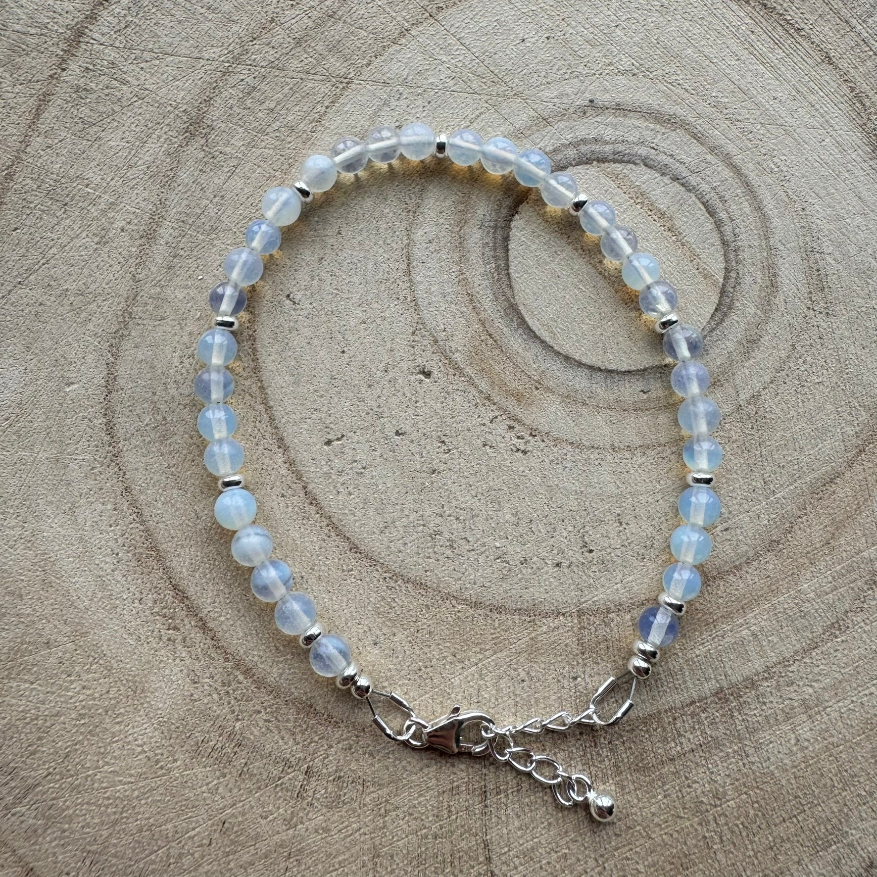 Sterling silver opalite bracelet on wooden surface