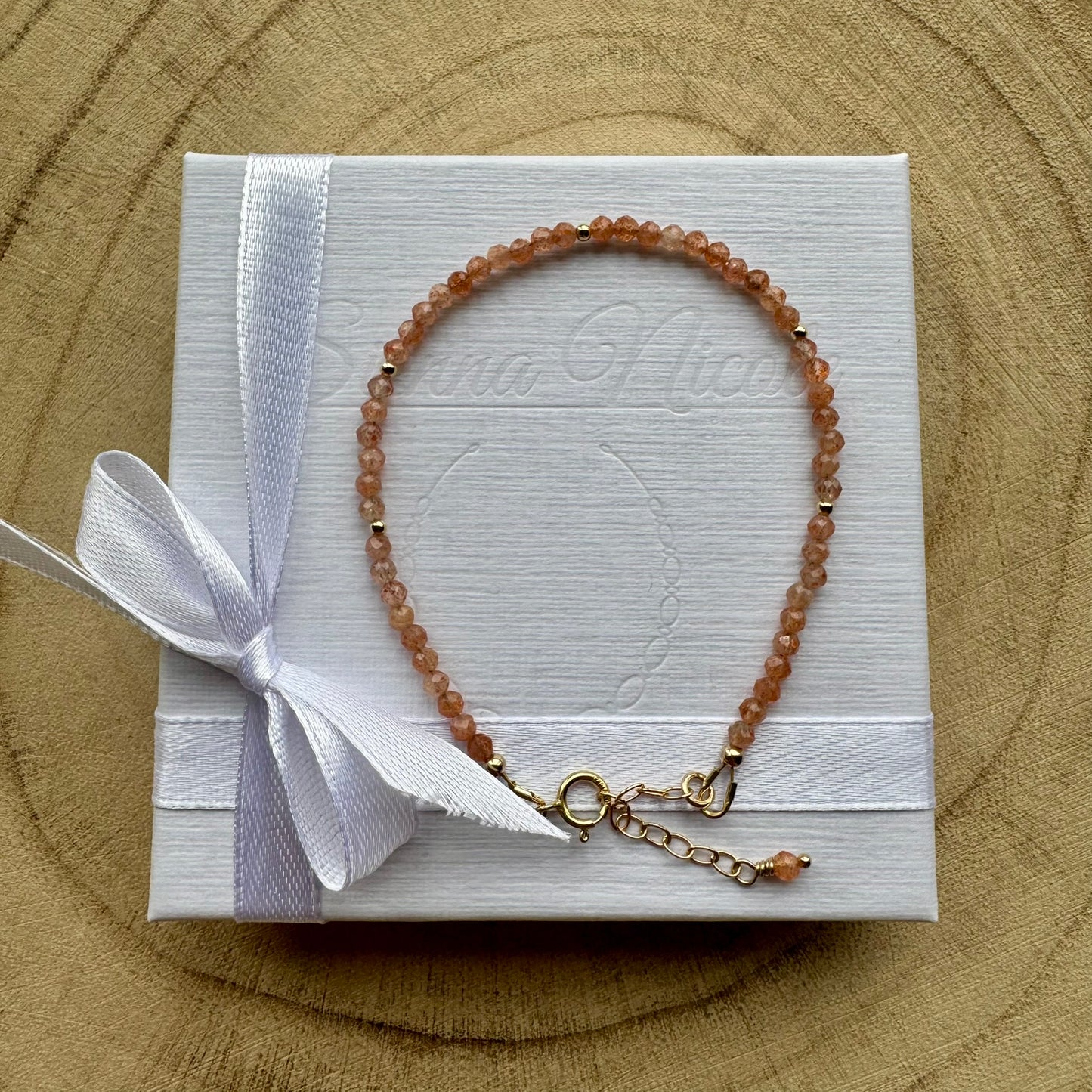 Peach sunstone bracelet with gold filled details on white gift packaging