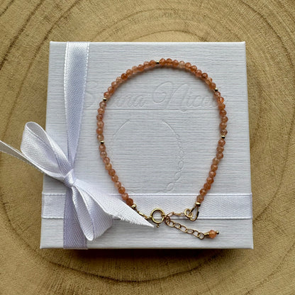 Peach sunstone bracelet with gold filled details on white gift packaging