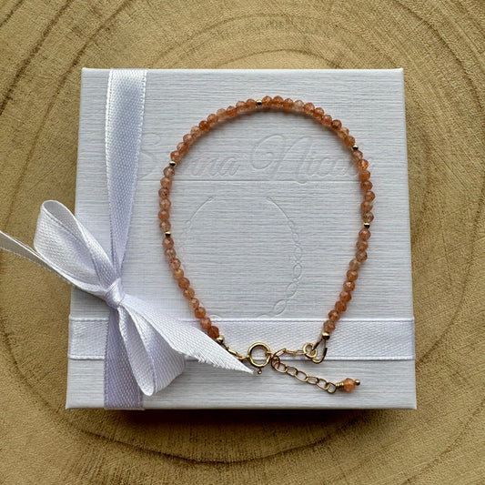Peach sunstone bracelet with gold filled details on white gift packaging